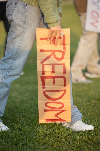 Close up hand holding freedom placard