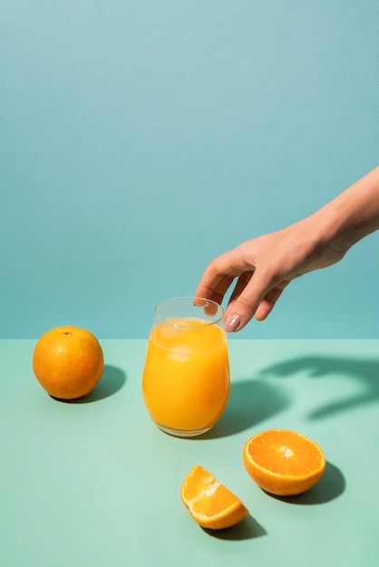 Close up hand holding glass with juice