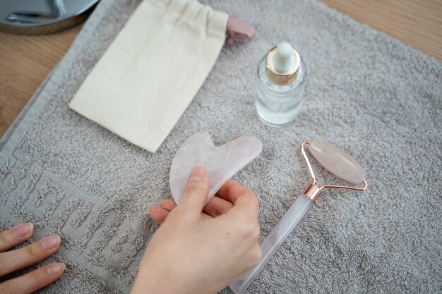 Close up hand holding gua sha tool