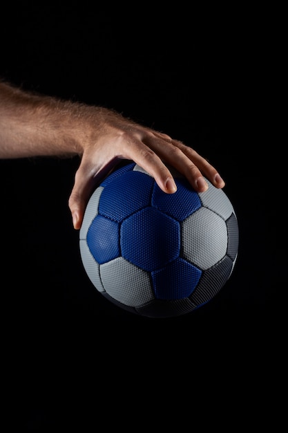 Free photo close up on hand holding handball ball