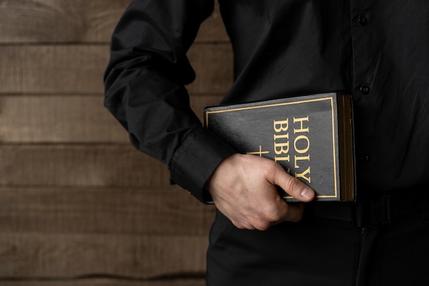 Close up hand holding holy bible