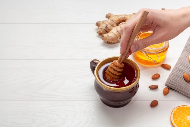 Close-up hand holding honey stick