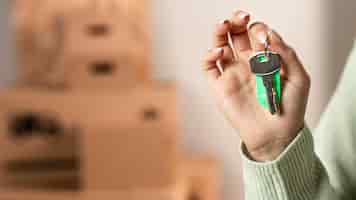Free photo close-up hand holding keys indoors