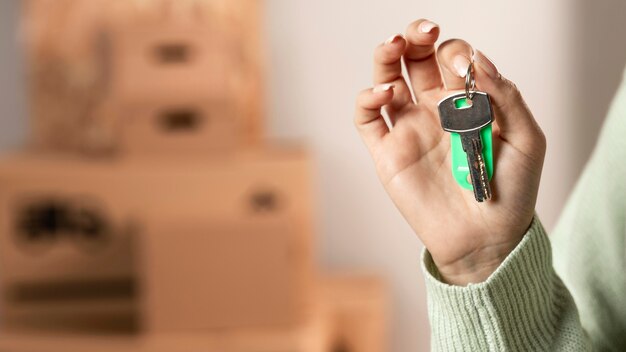 Close-up hand holding keys indoors