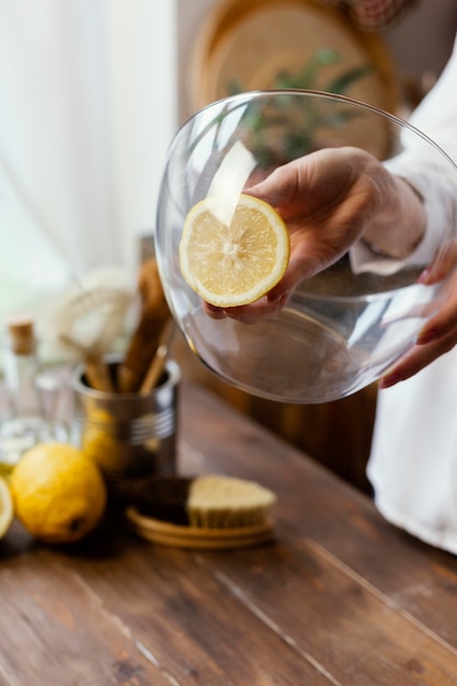 Close up hand holding lemon slice