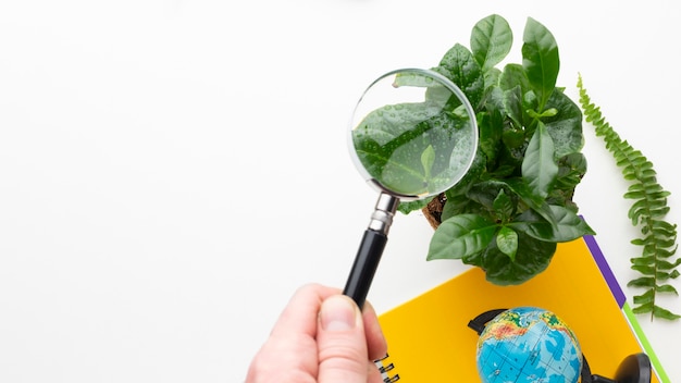 Free photo close-up hand holding magnifying glass