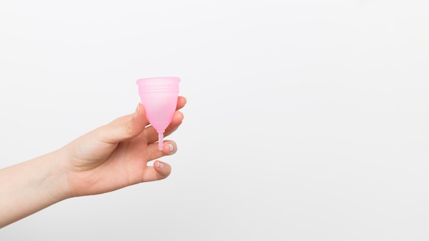 Close up hand holding menstrual cup 