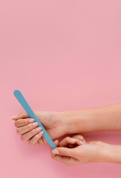 Close-up hand holding nail file