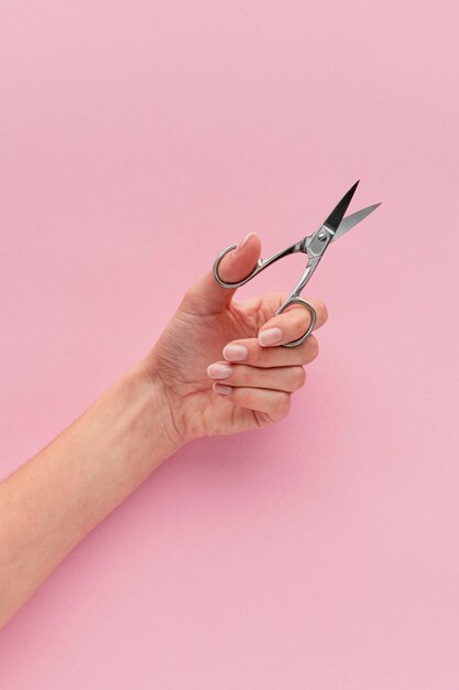 Close-up hand holding nail scissors