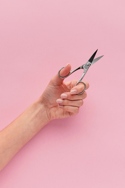 Close-up hand holding nail scissors