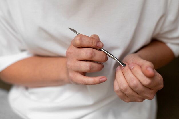 Close up hand holding nail tool