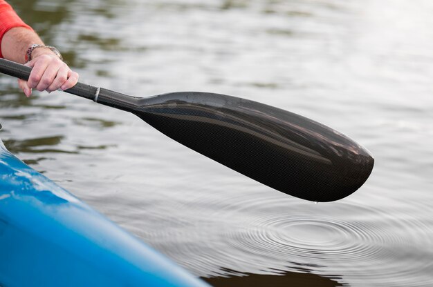 Close-up hand holding oar