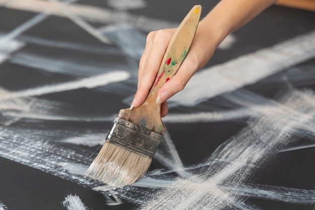 Close-up hand holding painting brush