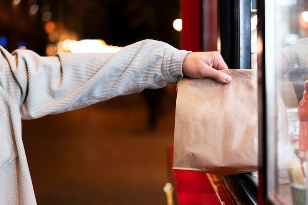 Close up hand holding paper bag