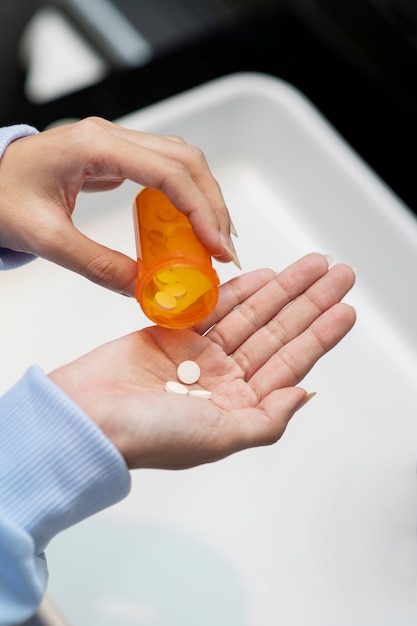 Close up hand holding pills