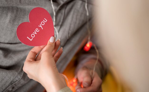 Close up hand holding pink heart