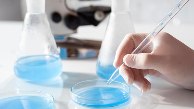 Close-up hand holding pipette