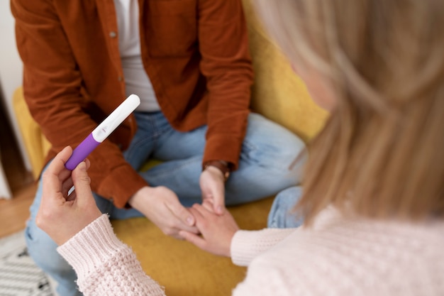 Close up hand holding pregnancy test