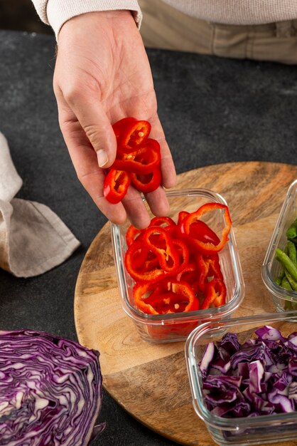 Close up hand holding red pepper