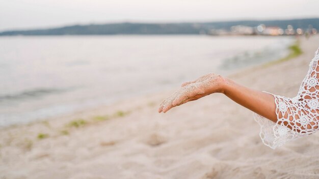 Close-up hand holding sand