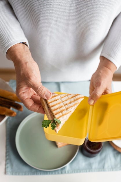 close up hand holding sandwich
