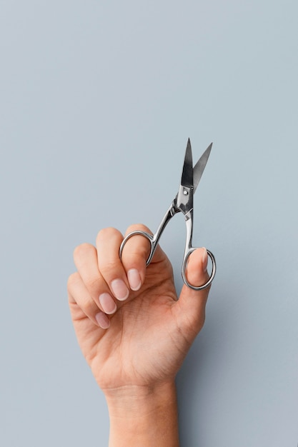 Free photo close-up hand holding scissors