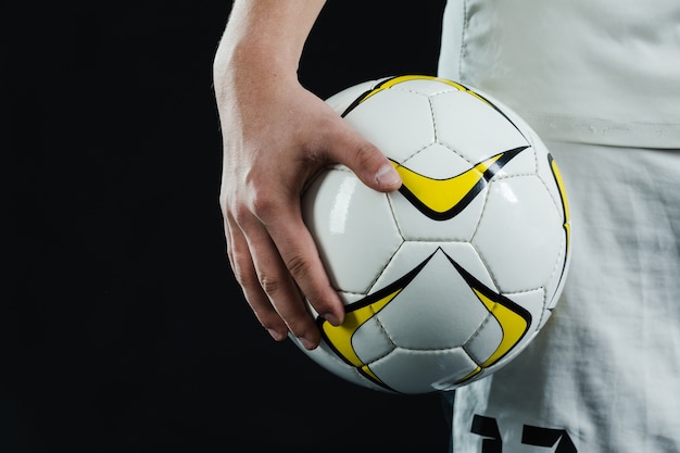 Close-up of hand holding a soccer ball