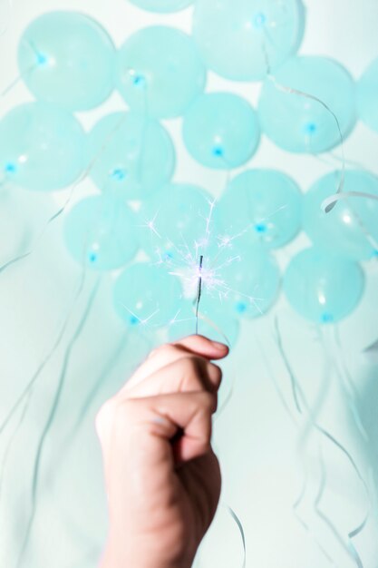 Close-up of hand holding sparkler under the decorative ceiling