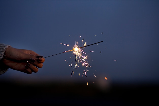 Free photo close up hand holding sparks