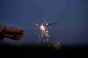 Free photo close up hand holding sparks