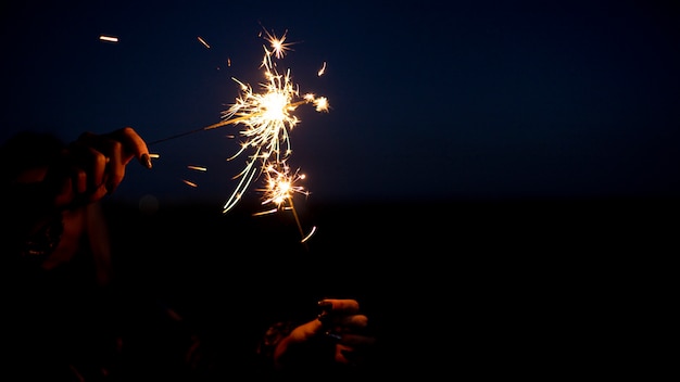 Close up hand holding sparks