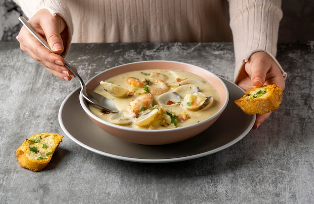 Free photo close-up hand holding spoon and bread