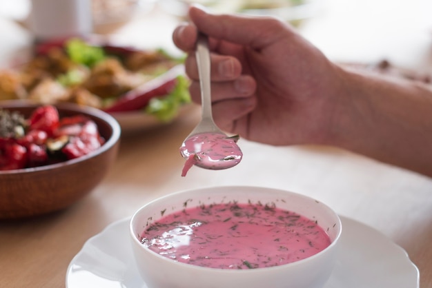 Close-up hand holding spoon