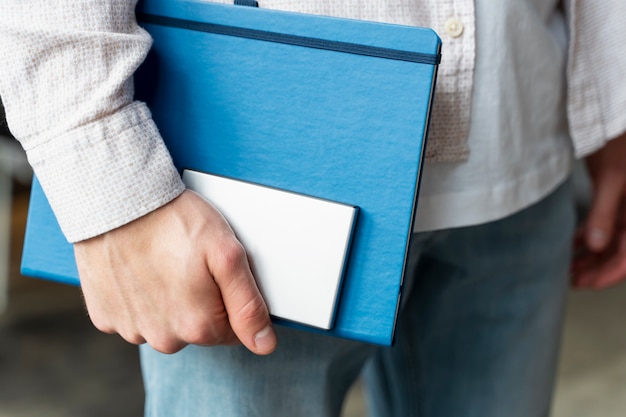 Free photo close up hand holding ssd and notebook