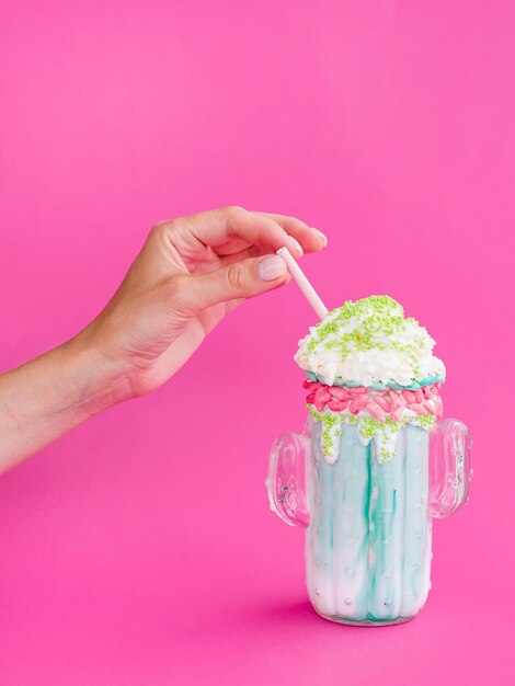 Close-up hand holding straw