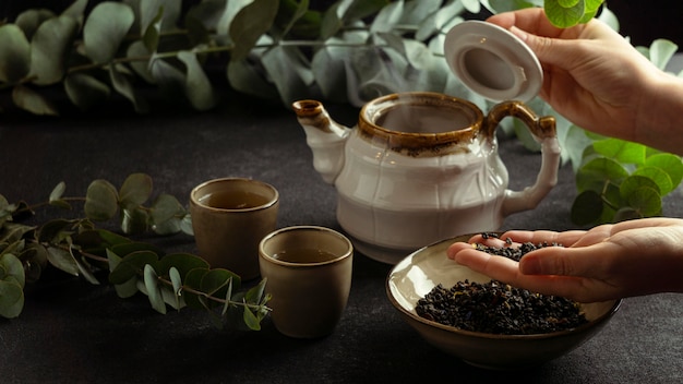 close-up hand holding tea ingredients