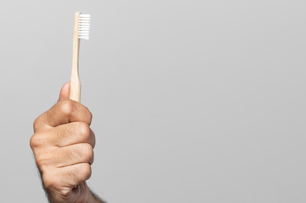 Close-up hand holding toothbrush