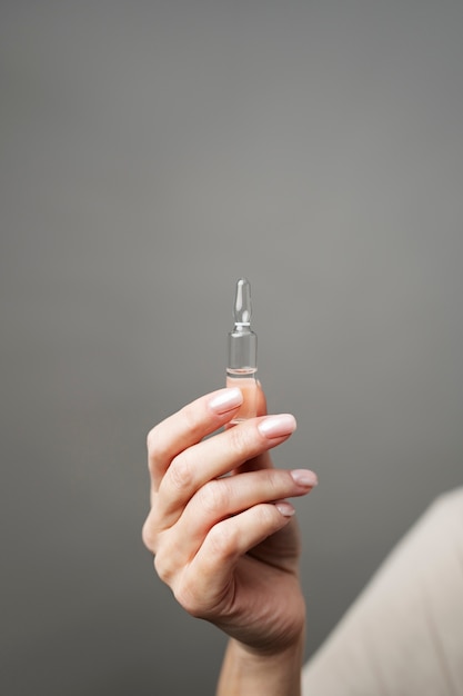 Close up hand holding vial