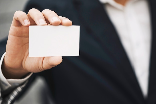 Close-up of hand holding visiting card