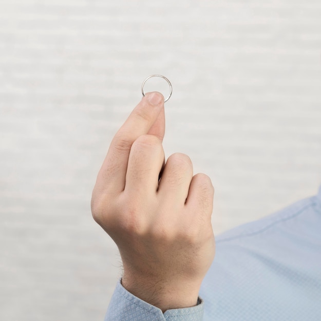 Close-up hand holding wedding ring