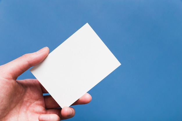 Close-up hand holding white business card