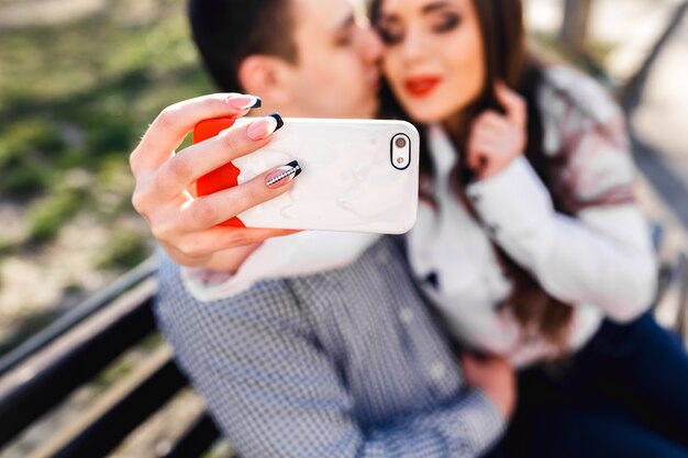 Close-up of hand holding a white mobile