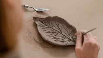 Free photo close-up hand making leaf