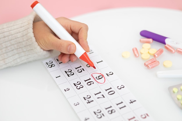 Close up hand marking calendar