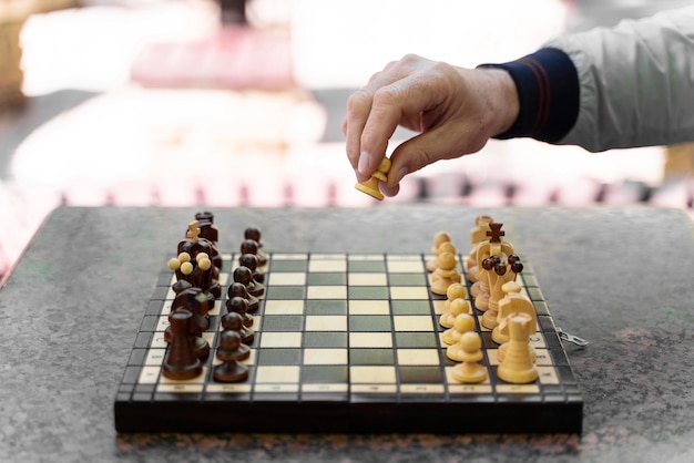 Close up hand moving chess piece