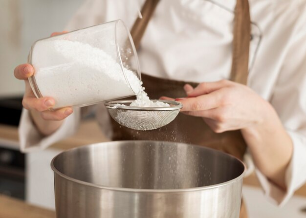 Close up hand pouring sugar