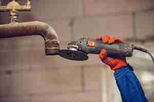 Free photo close up of hand of repairman, professional builder working indoors, repairing