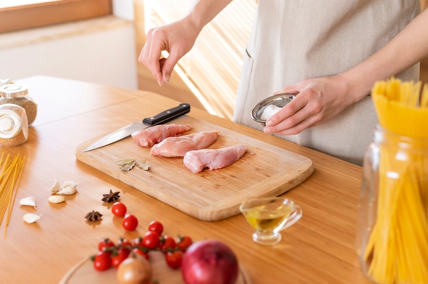 Close up hand salting food