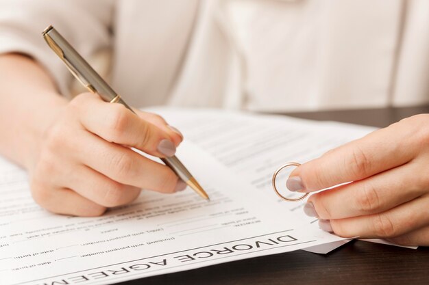 Close-up hand signing document