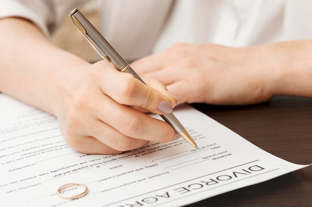 Close-up hand signing paper